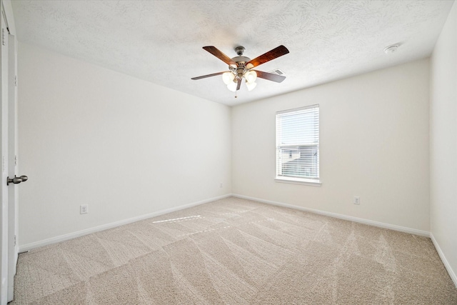 spare room with ceiling fan, carpet, and a textured ceiling