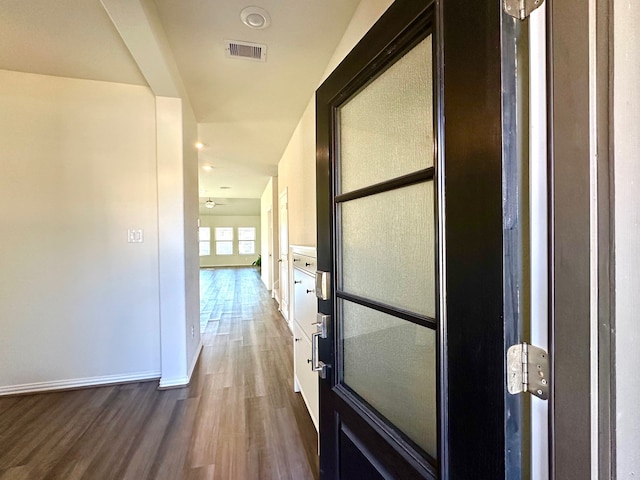 corridor featuring dark hardwood / wood-style flooring