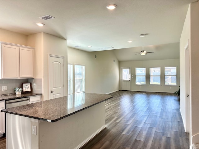 kitchen with a center island, dark wood finished floors, visible vents, and white cabinets