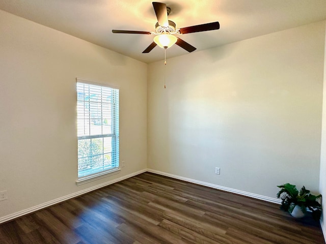 unfurnished room featuring ceiling fan, baseboards, and dark wood-style flooring