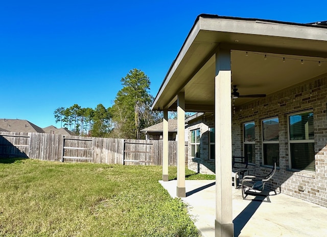 view of yard with fence and a patio