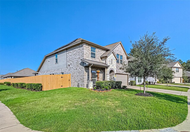 view of front of property with a garage and a front yard