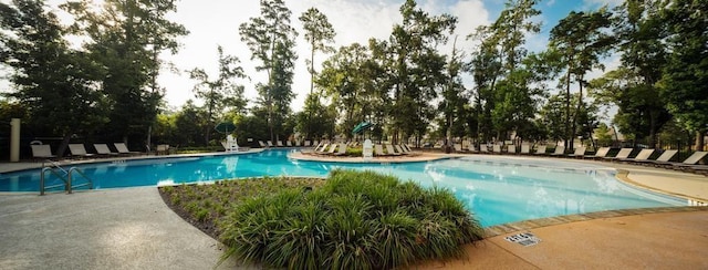 pool with a patio area and playground community