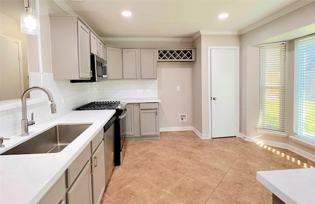 kitchen with decorative backsplash, appliances with stainless steel finishes, gray cabinetry, sink, and decorative light fixtures