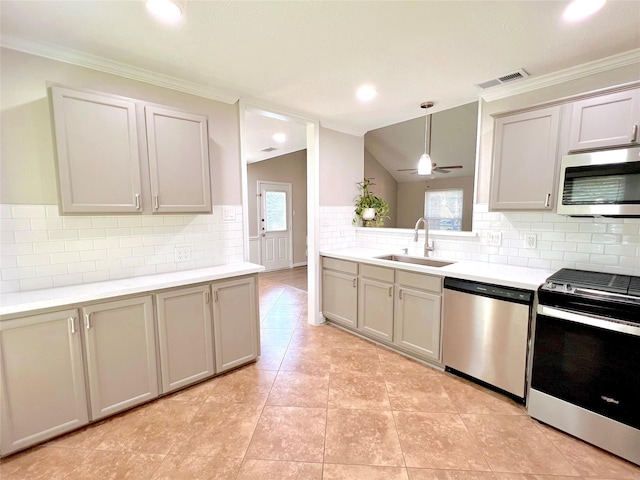 kitchen featuring ceiling fan, sink, stainless steel appliances, decorative light fixtures, and lofted ceiling