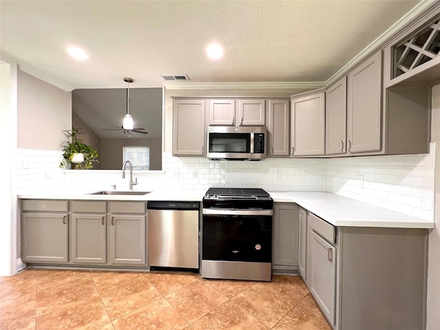 kitchen featuring gray cabinetry, pendant lighting, sink, and appliances with stainless steel finishes