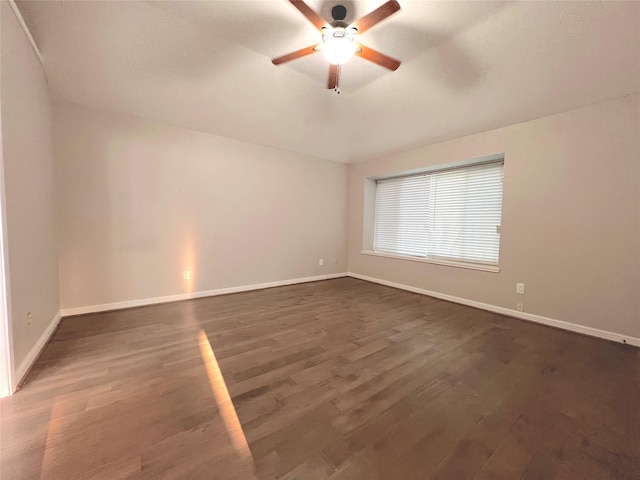 unfurnished room featuring ceiling fan and dark hardwood / wood-style floors