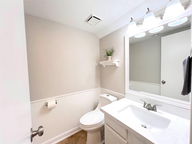 bathroom with tile patterned floors, vanity, and toilet