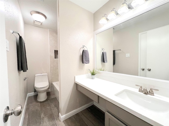 full bathroom featuring vanity, toilet, and washtub / shower combination