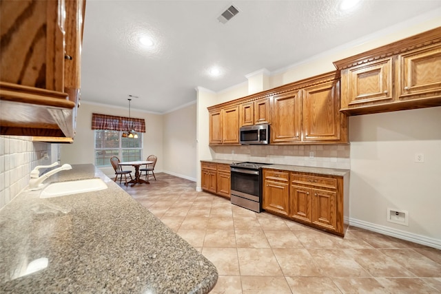 kitchen with backsplash, light stone counters, sink, and stainless steel appliances