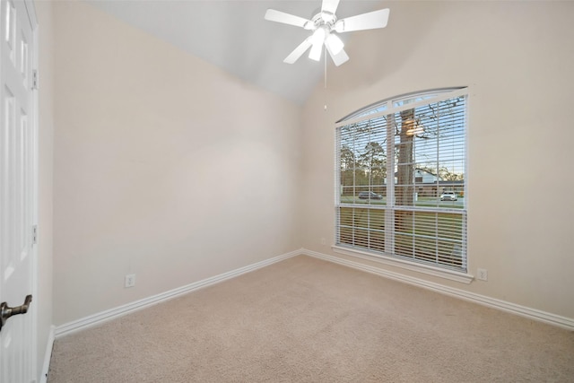 empty room featuring ceiling fan, carpet floors, and vaulted ceiling