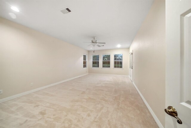 carpeted empty room with ceiling fan