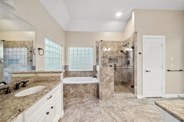 bathroom with vanity, independent shower and bath, and lofted ceiling