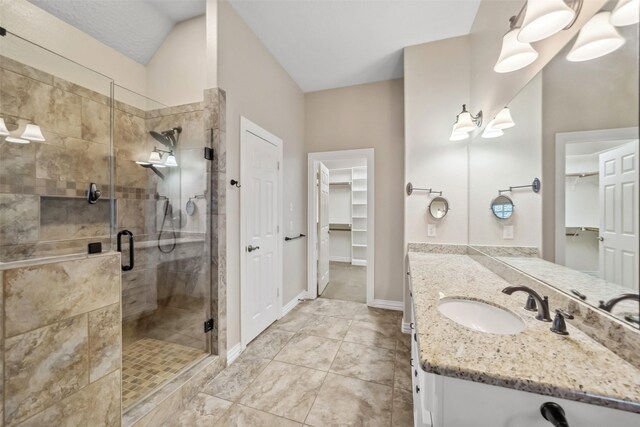 bathroom featuring vanity and a shower with door