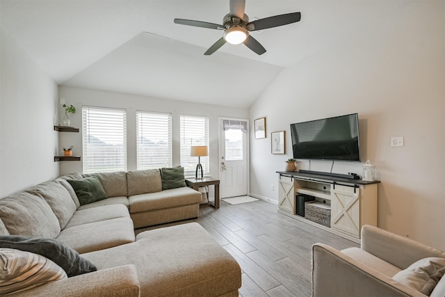 living room featuring plenty of natural light, light hardwood / wood-style floors, ceiling fan, and vaulted ceiling