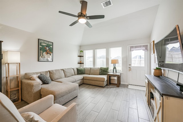 living room featuring ceiling fan, lofted ceiling, and light wood-type flooring