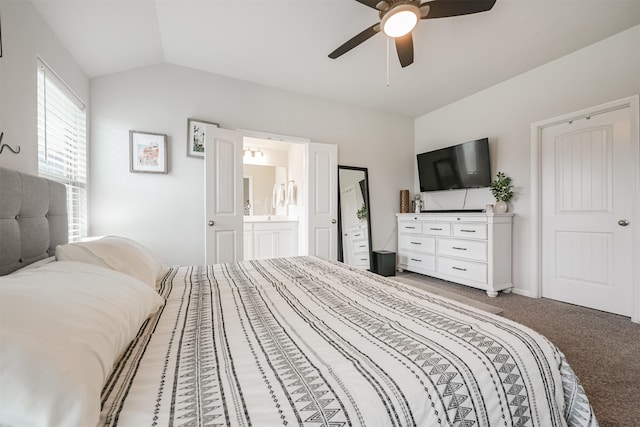 carpeted bedroom featuring ceiling fan, lofted ceiling, and ensuite bathroom