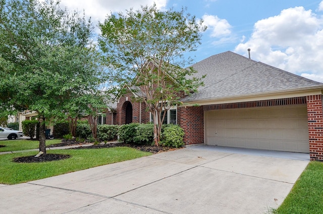 view of front of home featuring a front lawn and a garage