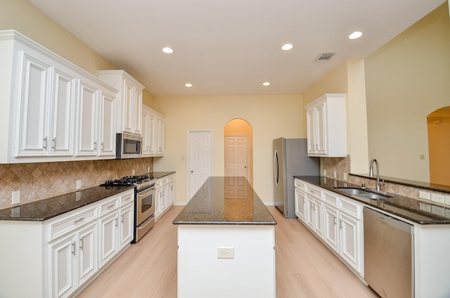 kitchen featuring white cabinetry, sink, appliances with stainless steel finishes, and tasteful backsplash