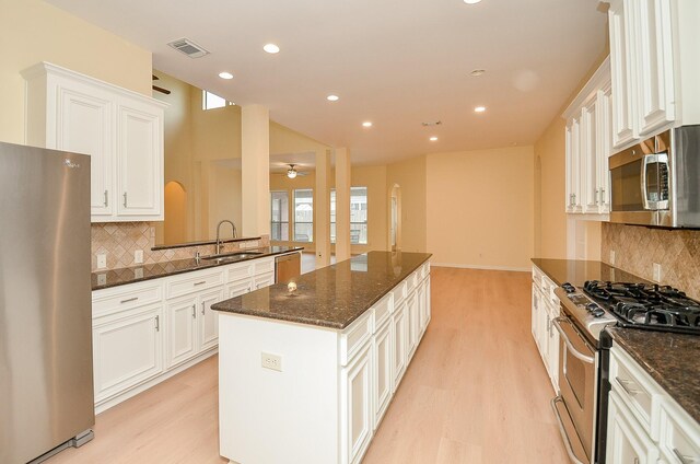 kitchen featuring white cabinetry, sink, a kitchen island, and stainless steel appliances