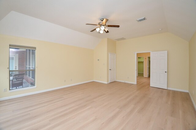 empty room featuring ceiling fan, lofted ceiling, and light wood-type flooring