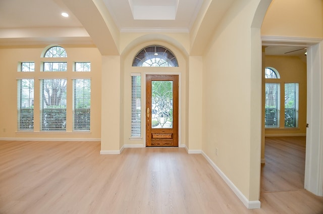 entrance foyer with plenty of natural light, light hardwood / wood-style floors, and ornamental molding