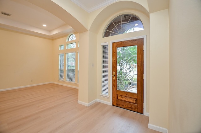 foyer featuring light hardwood / wood-style floors and ornamental molding