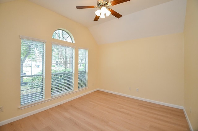 empty room with ceiling fan, lofted ceiling, and light wood-type flooring