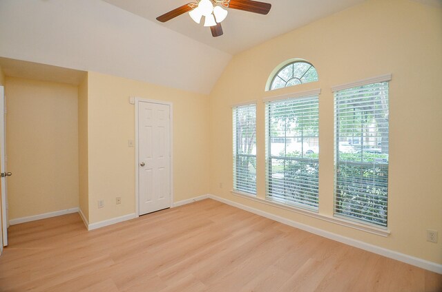 spare room with ceiling fan, vaulted ceiling, and light hardwood / wood-style flooring