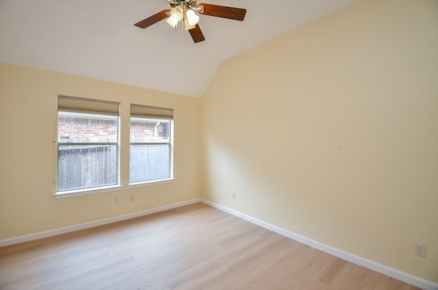 spare room with ceiling fan, light hardwood / wood-style flooring, and vaulted ceiling