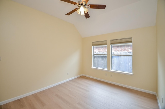 spare room featuring ceiling fan, light hardwood / wood-style floors, and vaulted ceiling