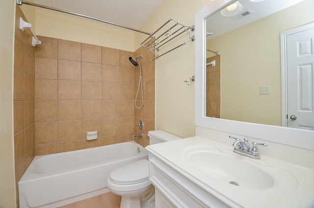 full bathroom with vanity, hardwood / wood-style floors, tiled shower / bath combo, and toilet