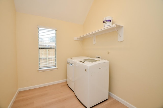 laundry room with light wood-type flooring and washing machine and clothes dryer