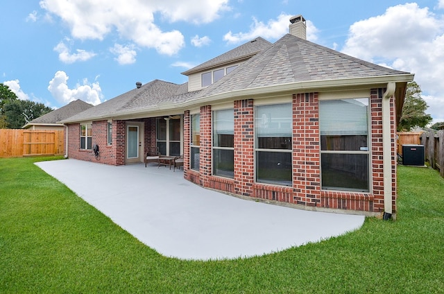 rear view of property featuring central AC, a patio area, and a lawn