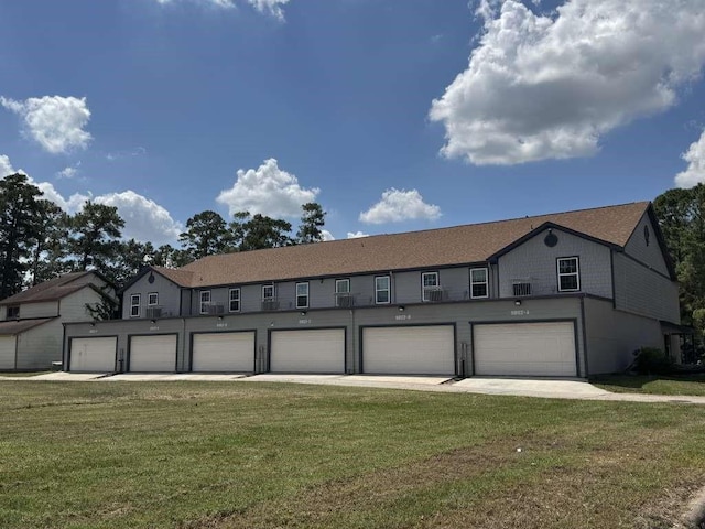 view of front of house with a garage and a front lawn