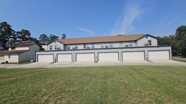 view of front of house with a garage and a front lawn