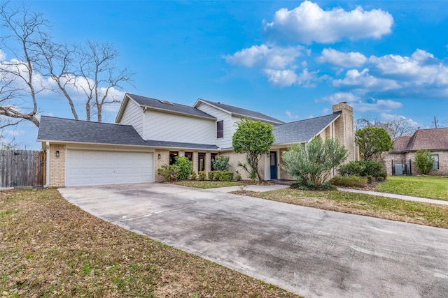 view of front of house with a garage and a front lawn