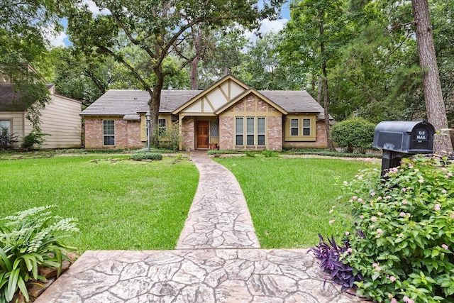 english style home featuring a front yard