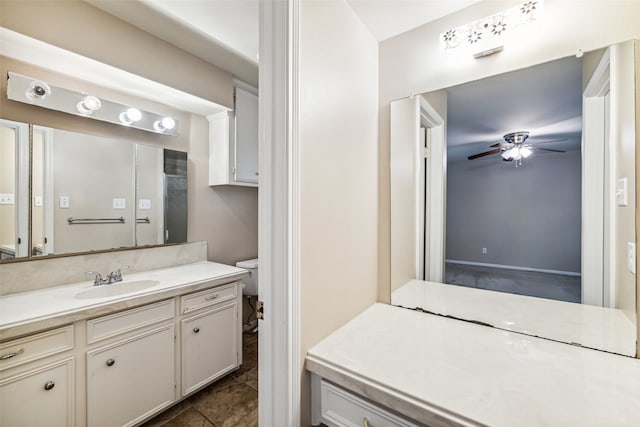 bathroom with vanity, toilet, and ceiling fan