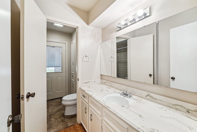 bathroom with vanity, a shower with shower curtain, and toilet