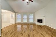 unfurnished living room featuring vaulted ceiling and hardwood / wood-style flooring