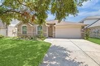 ranch-style house with a garage and a front yard