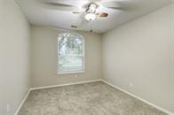 unfurnished room featuring light carpet