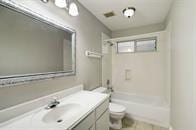 full bathroom featuring tile patterned floors, vanity, shower / tub combination, and toilet