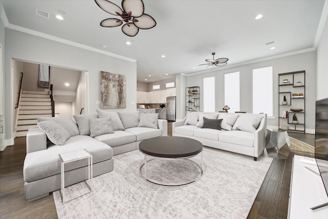 living room with ceiling fan, crown molding, and dark wood-type flooring