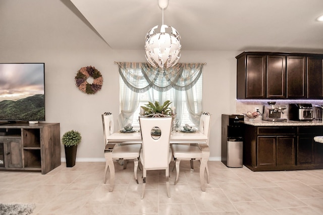 tiled dining room featuring a notable chandelier