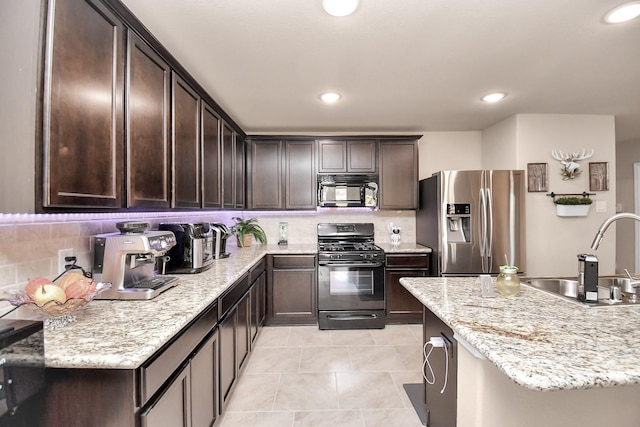 kitchen with decorative backsplash, sink, light tile patterned flooring, and black appliances