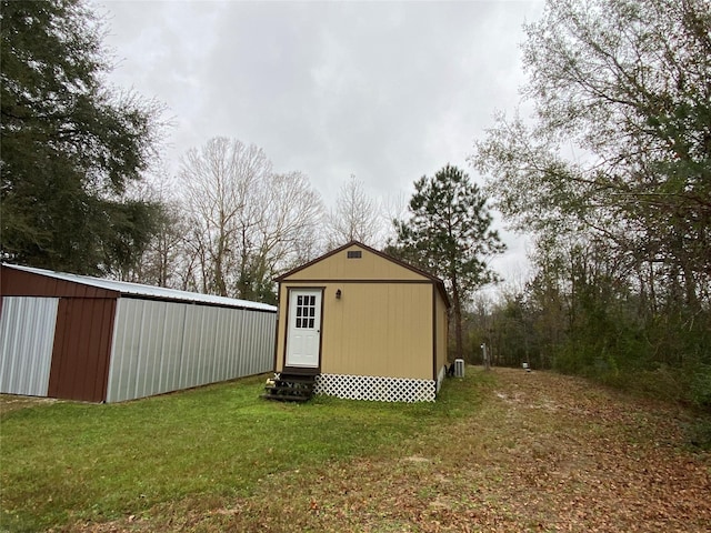 view of outdoor structure with a lawn