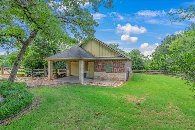 rear view of house with a patio area and a lawn