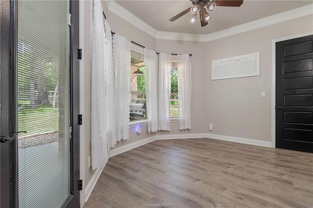 foyer with crown molding, ceiling fan, and light hardwood / wood-style floors